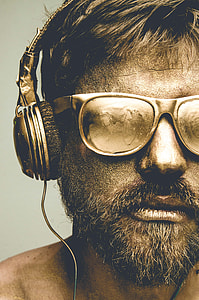 man wearing sunglasses and corded headphones