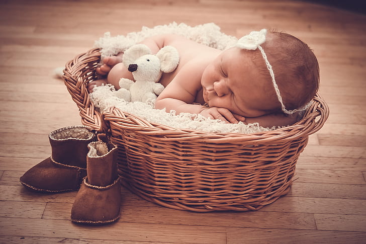 baby laying on wicker basket