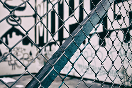 Close-up shot through a urban metal fence