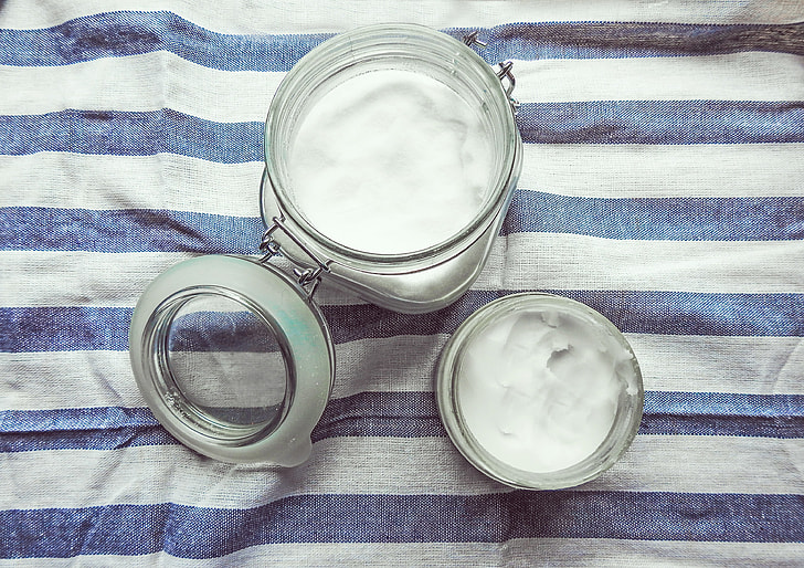 two clear glass mason jars with creams
