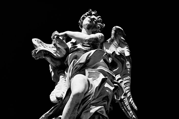 High-contrast monochrome shot of a statue on the River Tiber in Rome, Italy