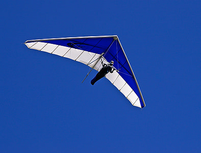 photo of person flying using glider kite