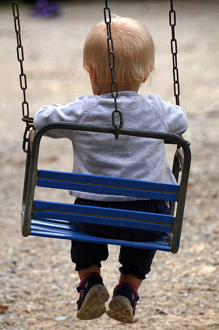 baby sitting on swing chair