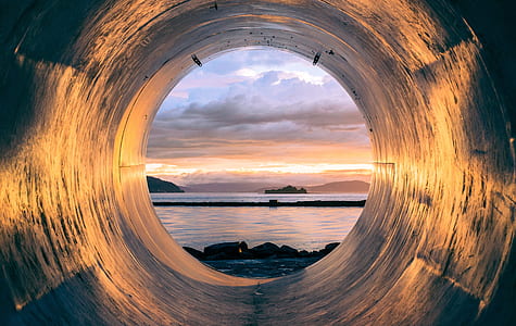 inside the hole photo of body of water during sunset
