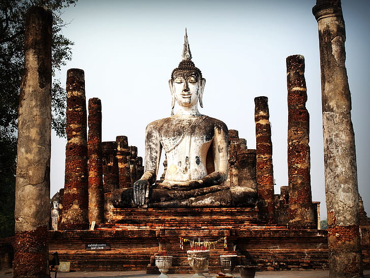 Gautama Buddha concrete statue surrounded with concrete columns
