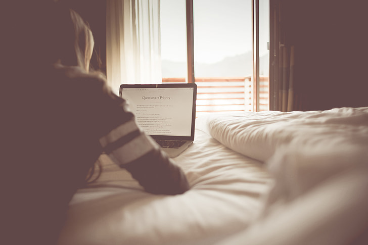 Girl Reading a Blog in a Bedroom