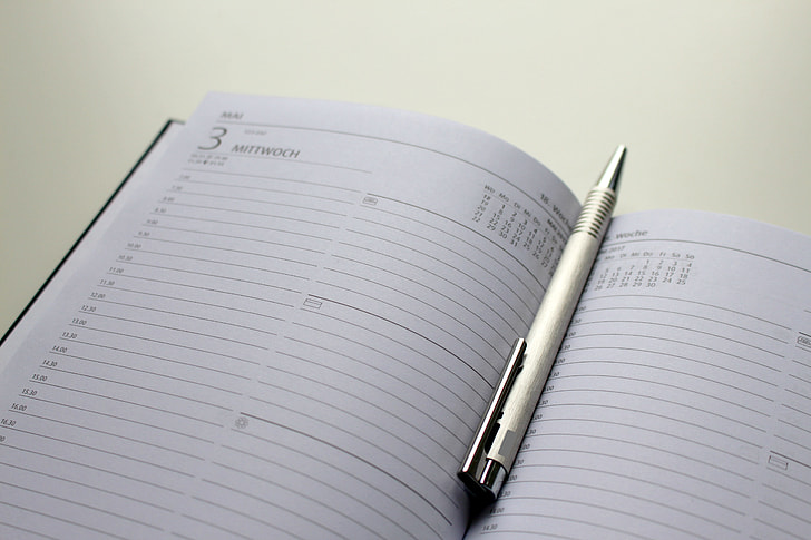 retractable pen inside business diary book