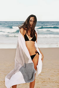 woman wearing swim suit on brown sand