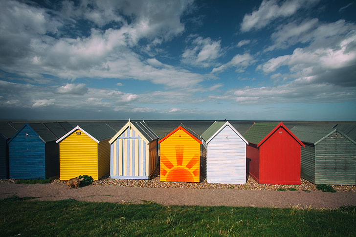 Wide-angle capture of some coastal beach huts on a summer day, image captured in Kent, England