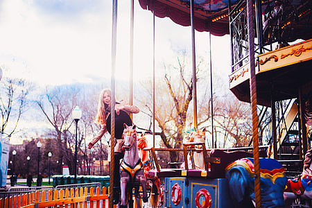 woman riding on carousel