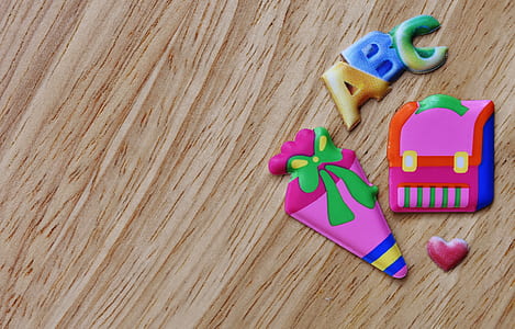 assorted-color toys on brown wooden surface