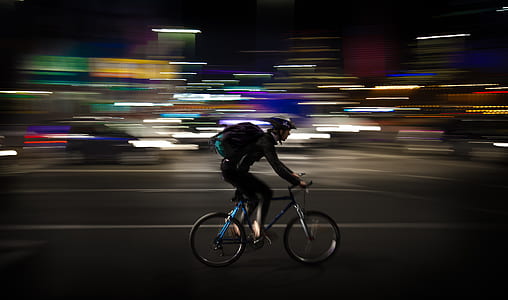 timelapse photography of man rigid bicycle