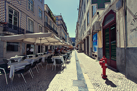 People site outside a restaurant in Lisbon, Portugal for some alfresco dining