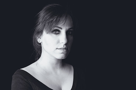 grayscale photography of a woman wearing black scoop-neck top