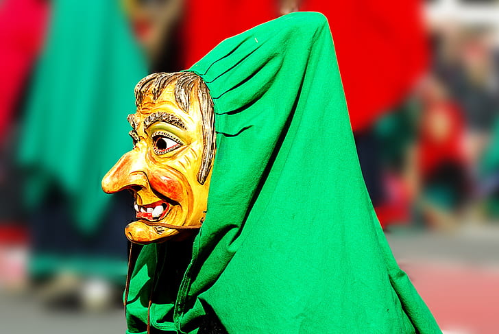 person wearing mask covered with green textile