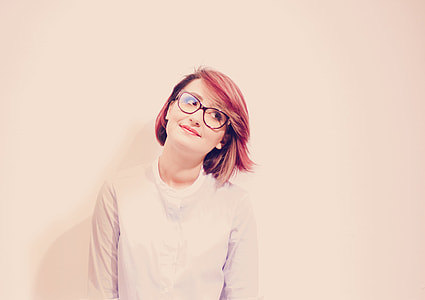 woman with red hair wearing white crew-neck shirt
