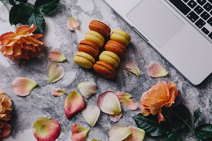 Overhead view of macarons on a marble slab