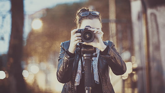woman holding camera taking picture