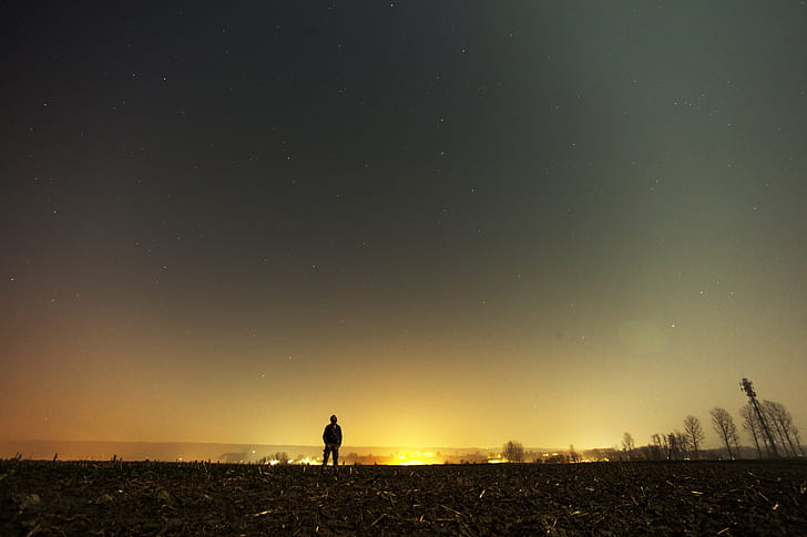 person standing under gray starry sky