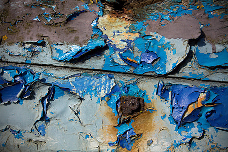 Close-up shot of some cracked and degraded blue wood. Image captured in Faversham, Kent, England with a Canon DSLR