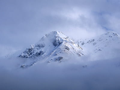 snow capped mountain with white clouds