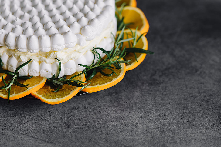 Meringue Cake with whipped cream and oranges