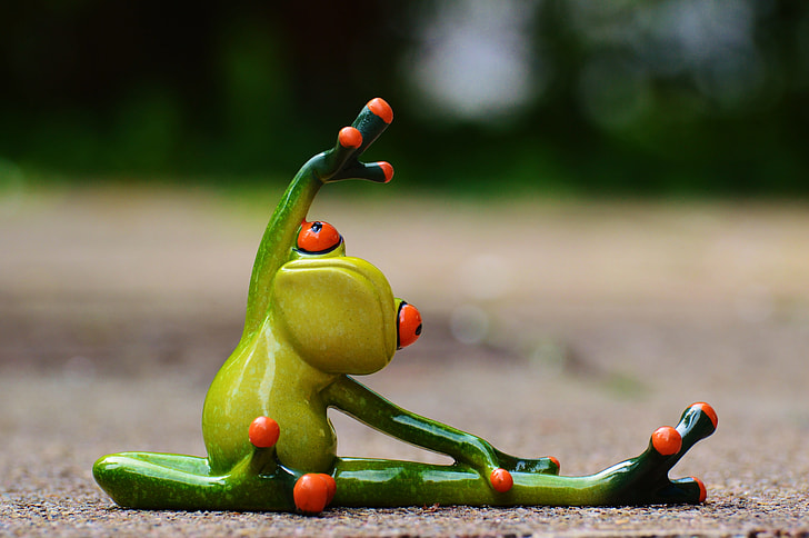 Royalty-Free photo: Green frog figurine doing yoga