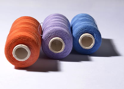 three orange, purple, and blue threads