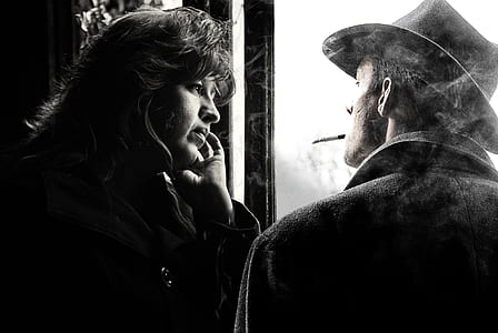 man and woman near standing near window grayscale photograph