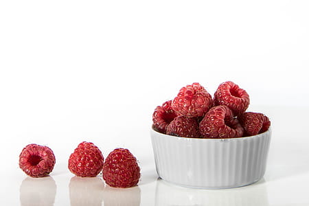 raspberries on white ceramic bowl