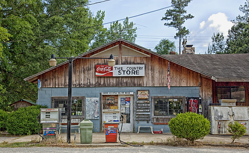 brown and gray wooden store with Coca-Cola signage
