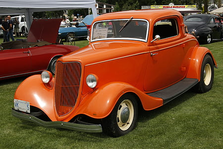 Orange Classic Coupe on Green Grass Field