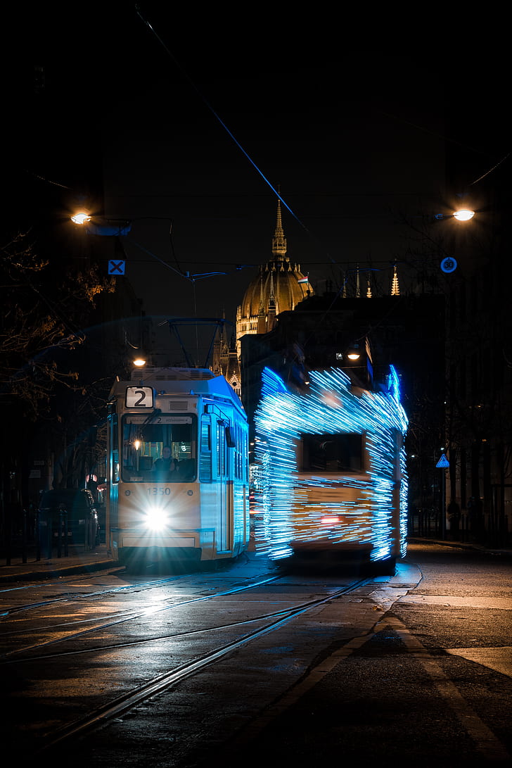 white and blue bus at night