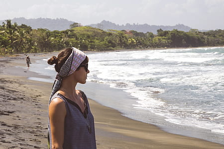 woman in gray sleeveless top looking into the ocean