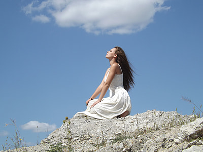 woman in white sleeveless dress looking at sky during daytime