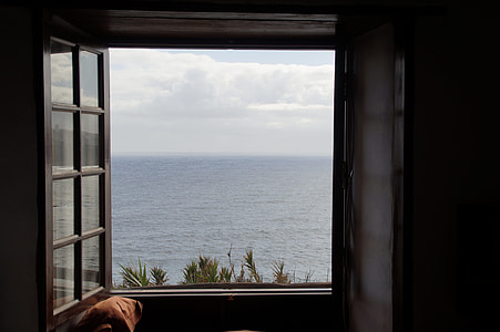 photo of open window near on ocean