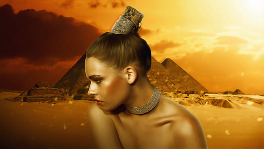 woman wearing necklace and hairband with pyramid background