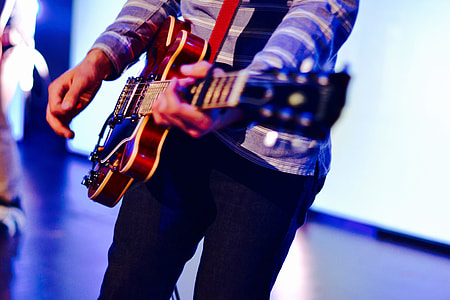 Man playing guitar on stage at a music concert