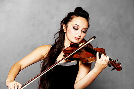 woman wearing black tank top playing violin