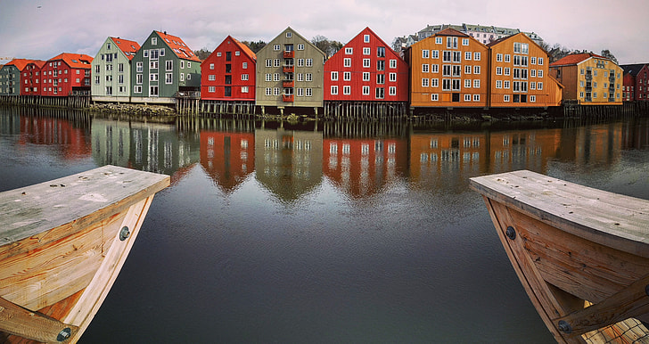 assorted color houses near body of water during daytime