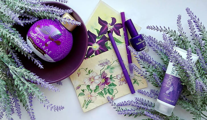 purple makeup kit and purple petaled flowers