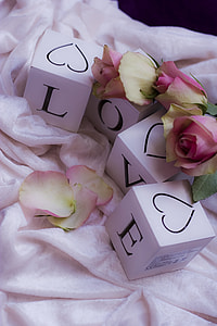 four white boxes with Love print