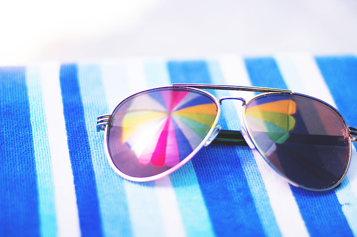 Summer sunglasses on beach towel
