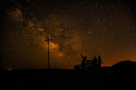 silhouette photography of people under the stars sky