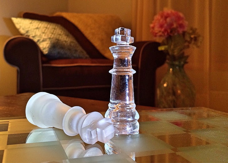two clear glass rook chess pieces