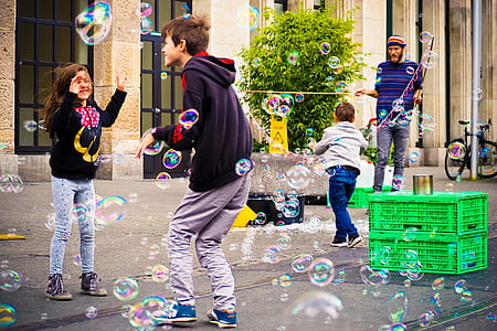 children playing bubbles during daytime