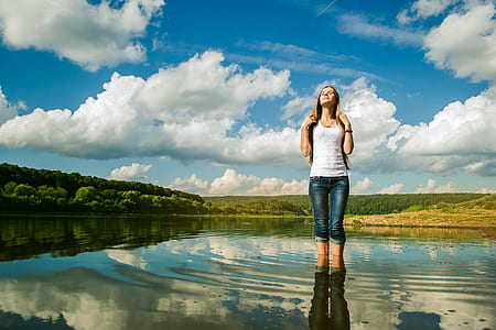 woman wearing white shirt standing in water