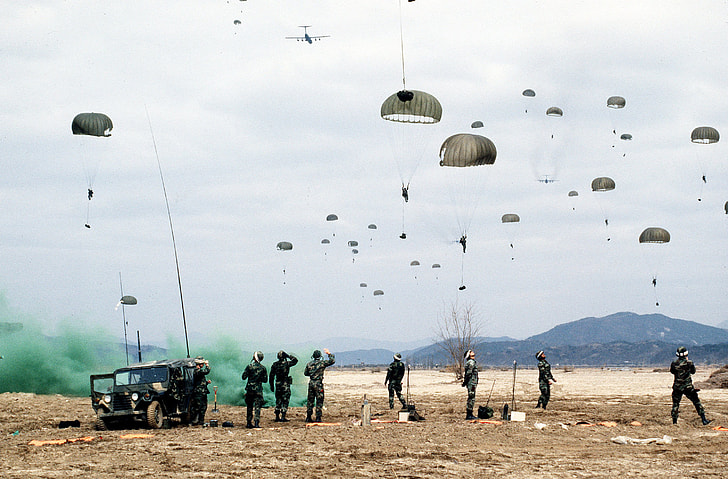 soldiers flying parachutes
