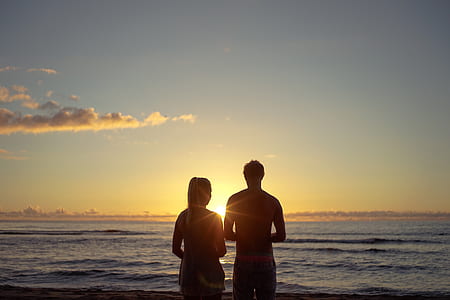 silhouette couple in front of beach