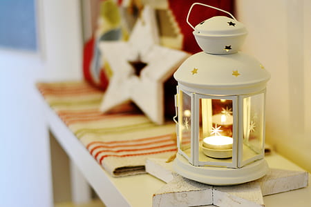 selective focus photography of lighted candle lantern